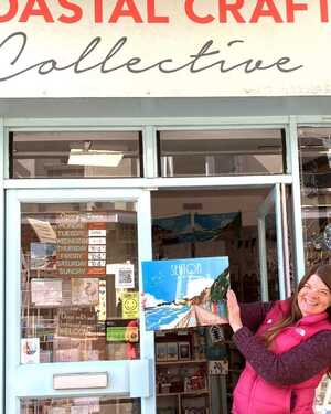 Store front of Coastal Craft Collective with shop owner Linda