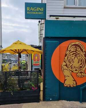 Outdoor seating area and restaurant at Ragini in Seaton